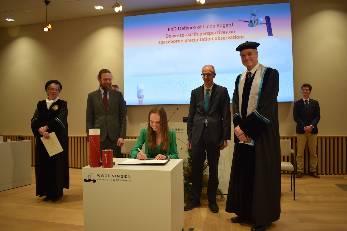 My PhD defence in December 2024. Here I am, signing my degree, with my three supervisors and the pedel (on the left). A pedel has the task to begin and end the defence and is part of the very traditional Dutch PhD ceremony.